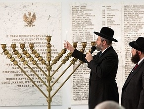 Rabbi David Lau, chief Ashkenazi rabbi of Israel, lights Hanukkah candles in the Sejm, the lower house of Poland’s Parliament, o